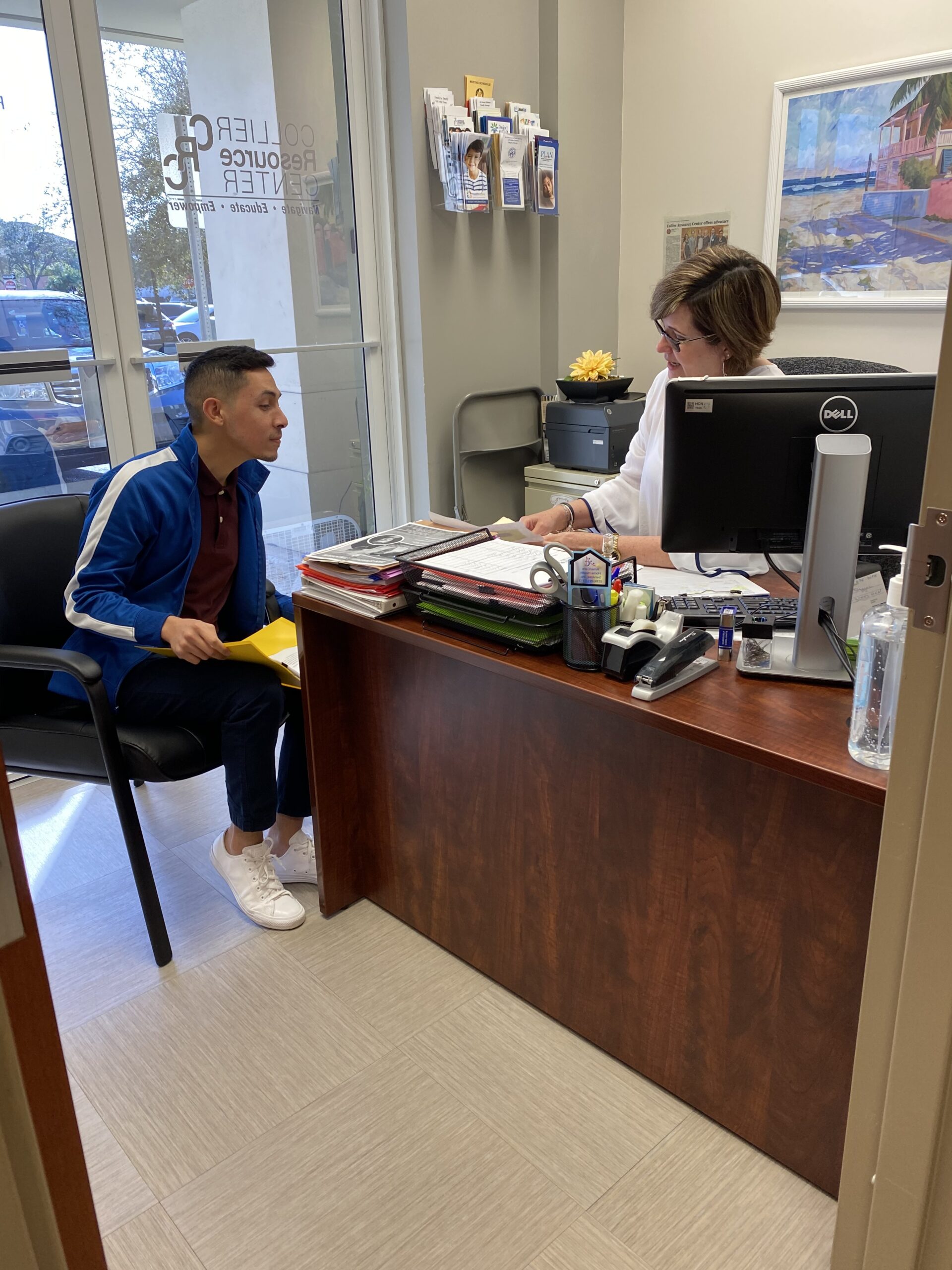 A CRC case manager meeting with a client at the Naples office